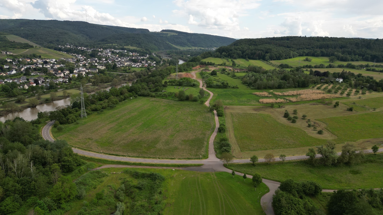 an aerial view of a rural area with a river running through it